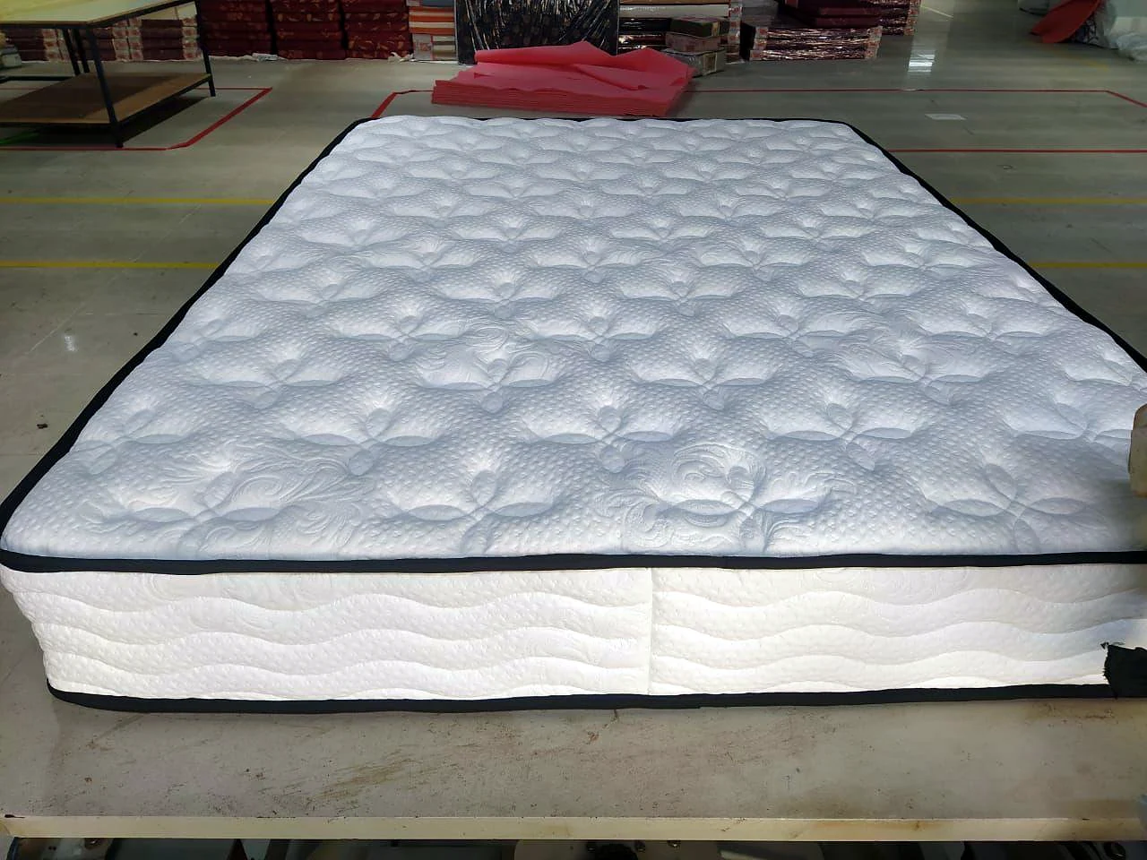 Mattress with knit cover and wave-stitched border at the Wood Crops factory, Chennai