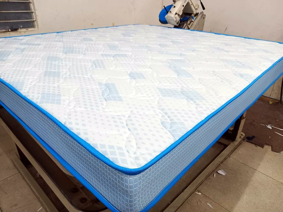 Queen size mattress with blue patterned quilting made at the Wood Crops factory, Chennai