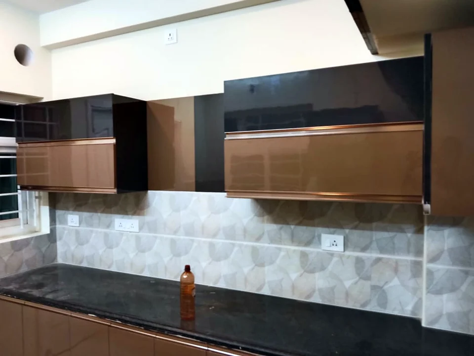 Modular kitchen with copper-finish wall cabinets and hexagon tile backsplash by Wood Crops, Chennai