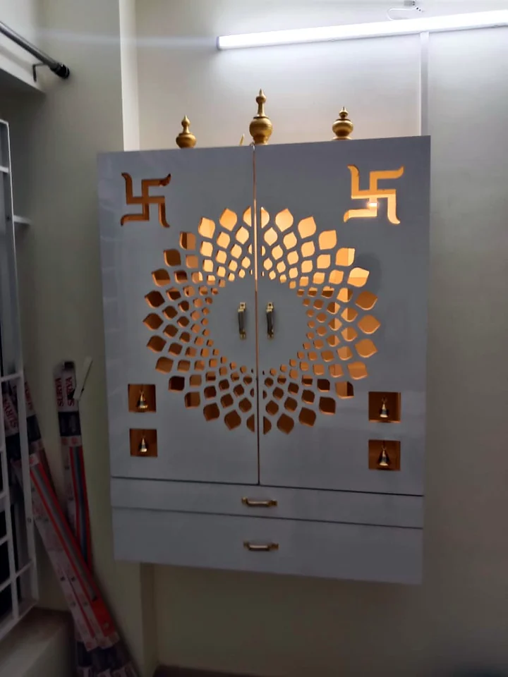 Wall-mounted pooja unit with backlit mandala jaali doors, made by Wood Crops, Chennai